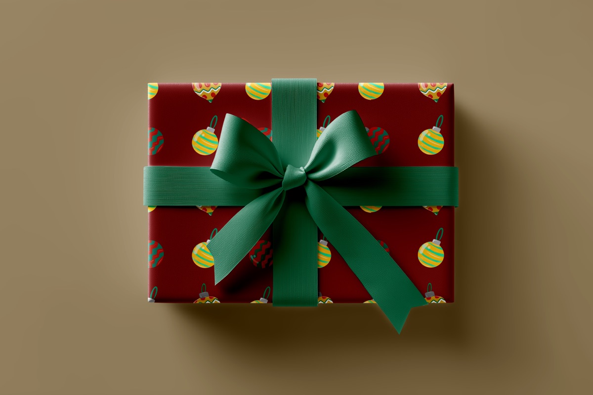 Gift wrapped in the ornament pattern with a green ribbon